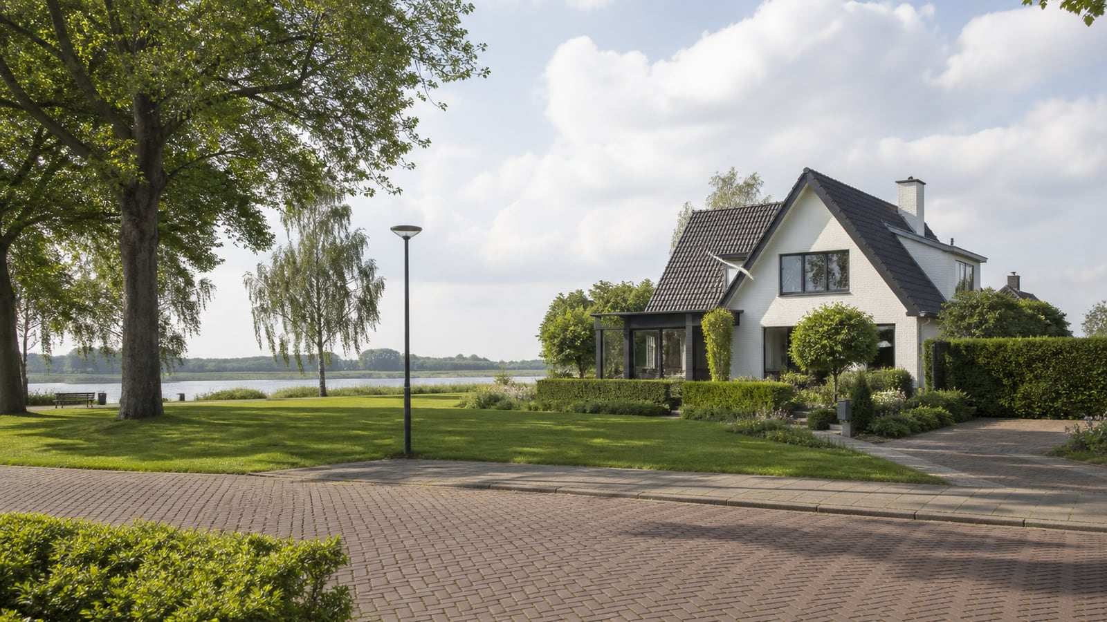 Fietser op een brede dijkroute met uitzicht over de Waal